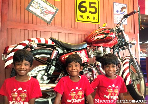 Kids posing with a abike